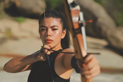 Portrait of young woman exercising in gym