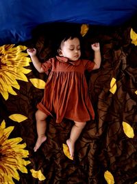 Baby sleep tight on the flower petals pattern bed cover