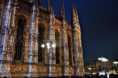 Low angle view of illuminated cathedral against sky at night