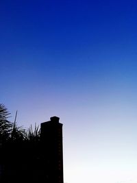 Low angle view of building against clear blue sky