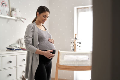 Pregnant woman standing at home