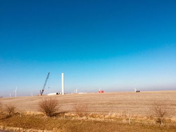 Scenic view of field against clear blue sky