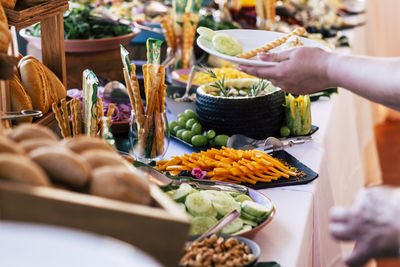 Cropped hand of woman holding plate in party