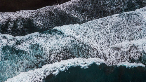 Aerial view of waves splashing in sea