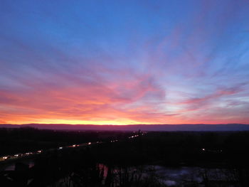 Scenic view of silhouette landscape against sky at sunset