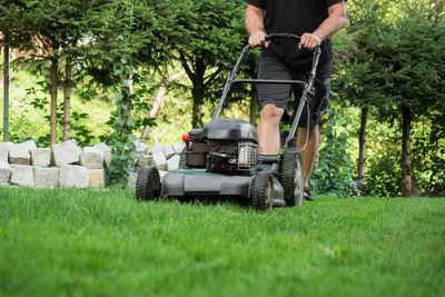 Low section of man gardening in park