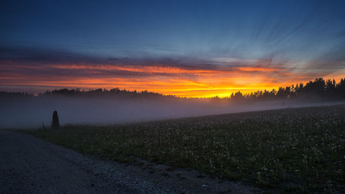 Scenic view of field against sky during sunset
