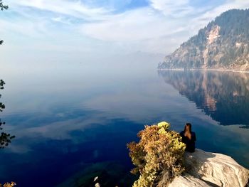 Pensive thoughts, reflection at crater lake, smoky sunrise