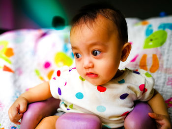 Close-up of cute baby girl drooling at home