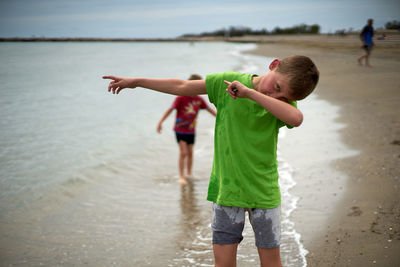 Full length of boy standing on beach