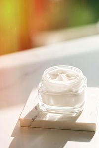 High angle view of face cream on white table
