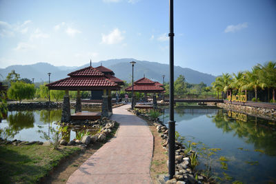 Scenic view of lake by buildings against sky