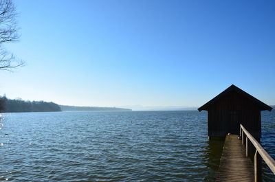 Scenic view of lake against clear blue sky