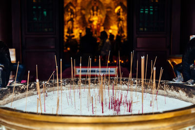 Close-up of burning incense in temple