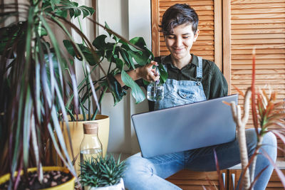 Portrait of young woman using digital tablet