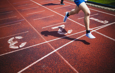 Low section of athlete running on sports track