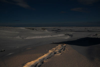 Scenic view of desert against sky during winter