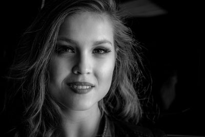 Close-up portrait of smiling young woman