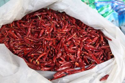 Close-up of dry red chili peppers in plastic bag