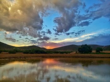 Scenic view of lake against sky at sunset