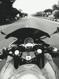 Close-up of person riding motorcycle on road