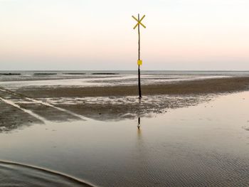 Scenic view of beach against sky during sunset