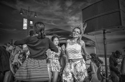 Low angle view of people against sky