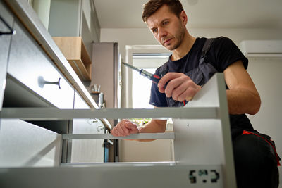 Close-up of man working at home