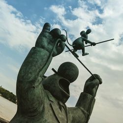 Low angle view of statue against sky