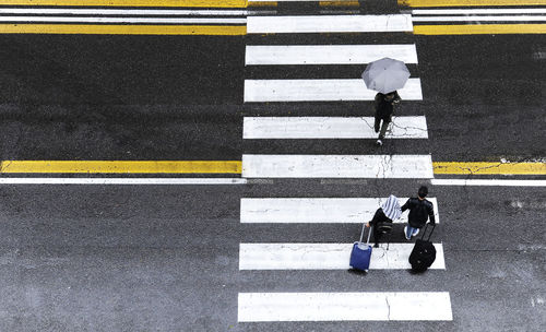 High angle view of man crossing road