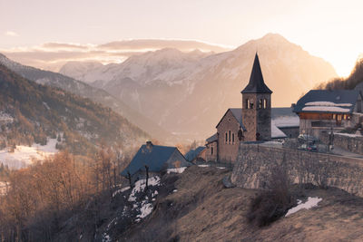 Church and old village of vaujany on the adret of rissiou, above flumet in isère in france.