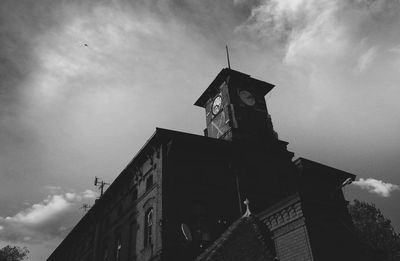 Low angle view of building against cloudy sky