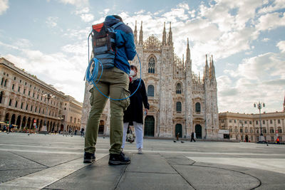 Rear view of people walking on street