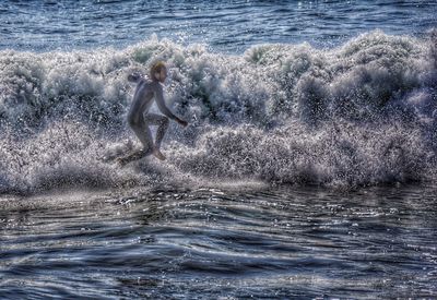 Woman jumping in sea