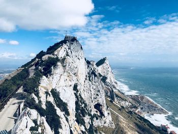 Panoramic view of sea and rock formation against sky