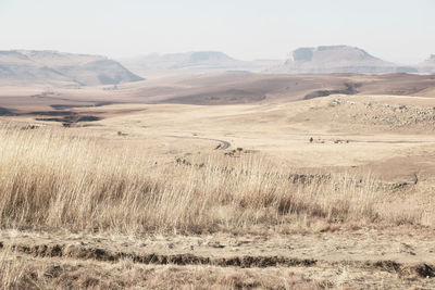 Scenic view of land and mountains against sky