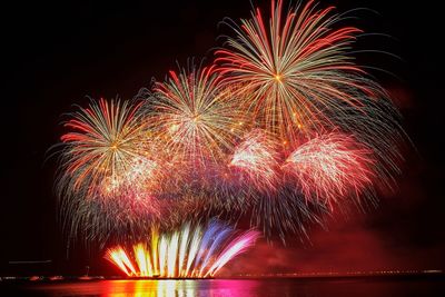 Low angle view of firework display at night