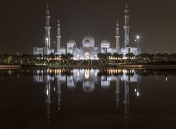 Reflection of illuminated buildings in lake at night