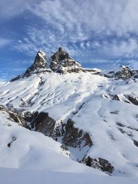 Scenic view of snow covered mountains against sky