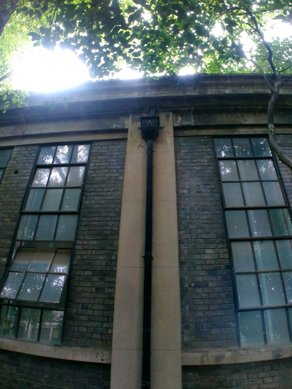 architecture, built structure, building exterior, window, low angle view, building, tree, glass - material, brick wall, sunlight, day, house, residential building, residential structure, outdoors, no people, old, door, city, closed