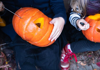 High angle view of man holding pumpkin during halloween