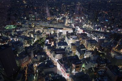 High angle view of city lit up at night