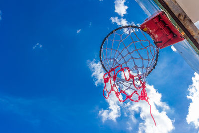 Low angle view of basketball hoop against blue sky