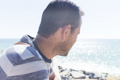 Man looking at sea on sunny day