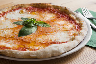 Close-up of pizza in plate on table