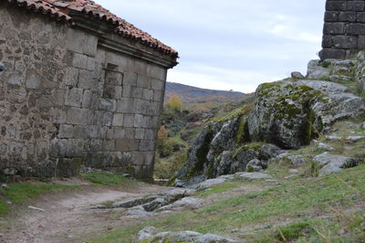 View of built structure on landscape against sky