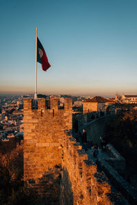 View of flag on building against blue sky