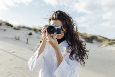 Woman photographing with camera