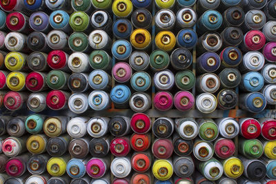 Full frame shot of multi colored spray paint cans
