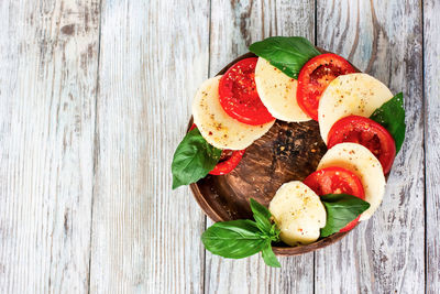 Directly above shot of fruits and leaves on table